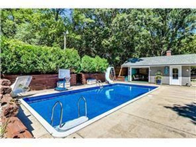 heated pool with slide, pool house photo provided by previous seller | Image 39