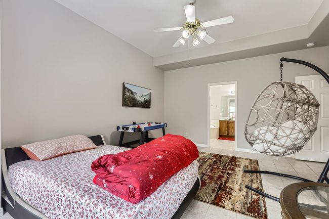 Tiled bedroom with connected bathroom and ceiling fan | Image 15