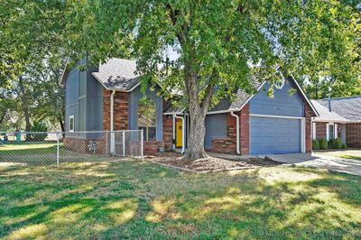 The sunny bright front door brings out the colors on the home. | Image 2