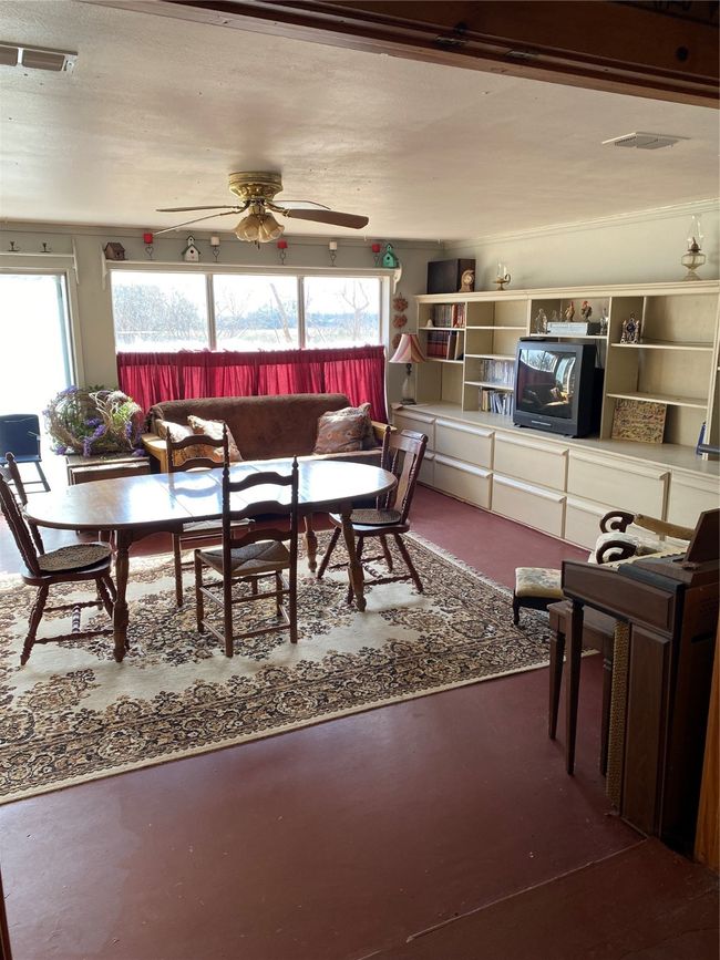 Dining room with concrete floors and ceiling fan | Image 8