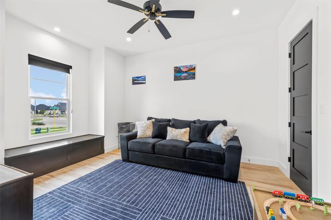 Living area with recessed lighting, a ceiling fan, wood finished floors, and baseboards | Image 20