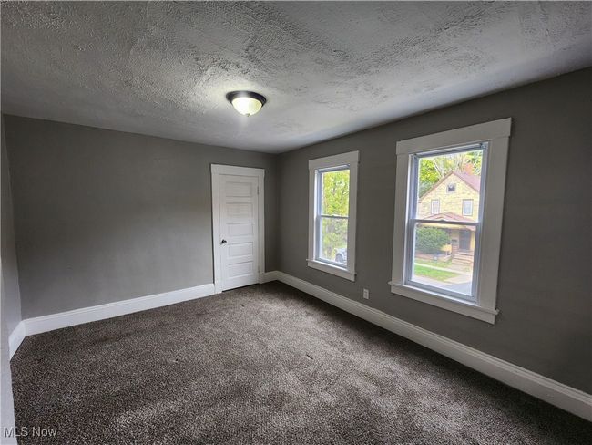 Unfurnished room with carpet floors and a textured ceiling | Image 16