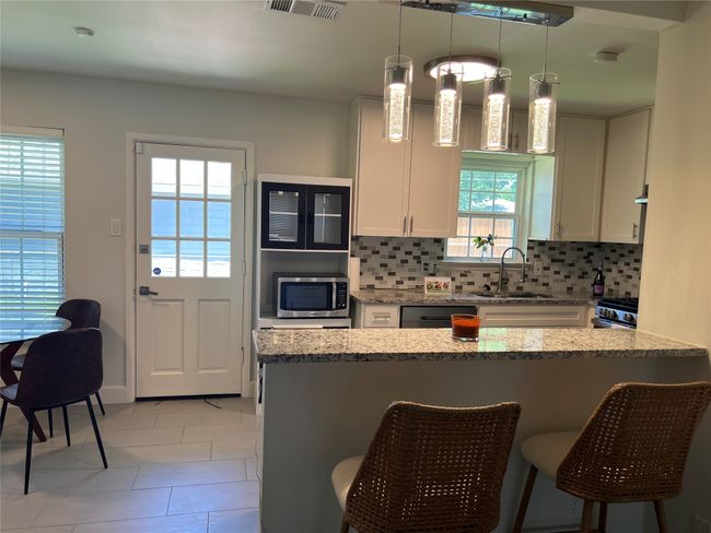 Pretty kitchen with island, back door to backyard and separate guest house | Image 8