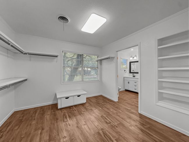 Walk in closet with wood finished floors | Image 9