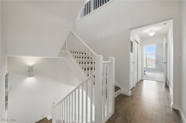 Stairs featuring wood finished floors and baseboards | Image 19
