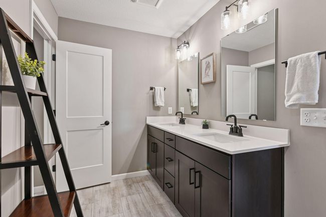 You'll love the comfort-height vanity with quartz countertops. | Image 11