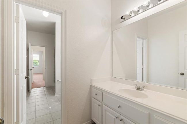 A Jack-and-Jill bathroom shared by two secondary bedrooms. | Image 25
