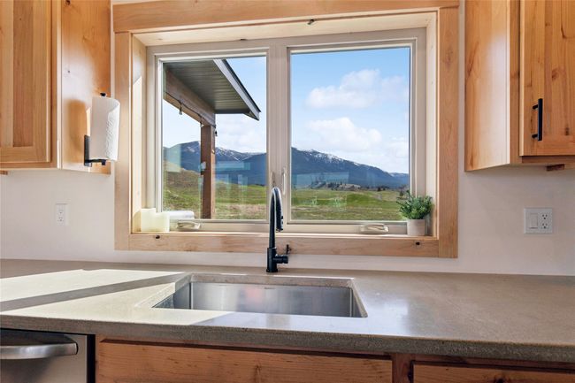 Kitchen with stainless steel dishwasher, a mountain view, and a sink | Image 19