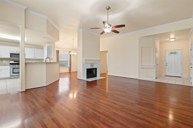 The hallway by the fireplace leads to the secondary bedrooms and bathroom. | Image 9