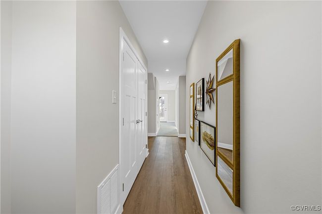 Corridor with visible vents, dark wood-style flooring, baseboards, and recessed lighting | Image 10