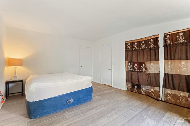 Bedroom with wood finished floors | Image 18
