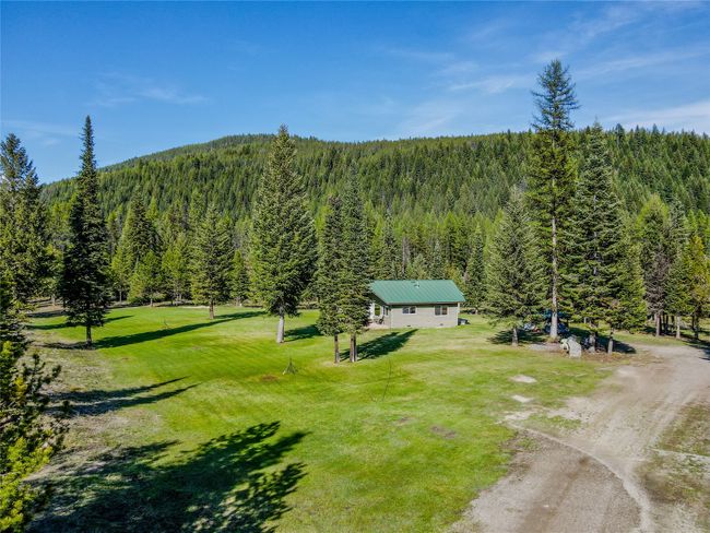 View from above of property featuring a heavily wooded area | Image 60