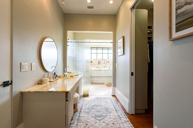 The second primary bath enhances its spa-like ambiance with an aeration soaking tub and oversized shower positioned right beside it. | Image 41