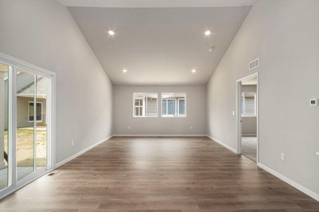 The open concept floorplan has full sight lines into the great room. There is an abundance of natural lighting from windows and is further enhanced by the vaulted ceilings and recessed lighting. | Image 10