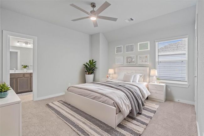 Secondary bedroom features plush carpet, custom paint, ceiling fan with lighting, large window with privacy blinds, and its own private access to a secondary bathroom. | Image 20