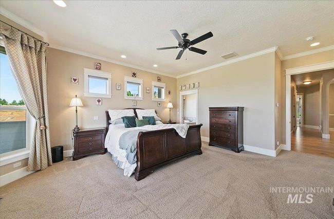Bedroom with light colored carpet, recessed lighting, ornamental molding, and ceiling fan | Image 18