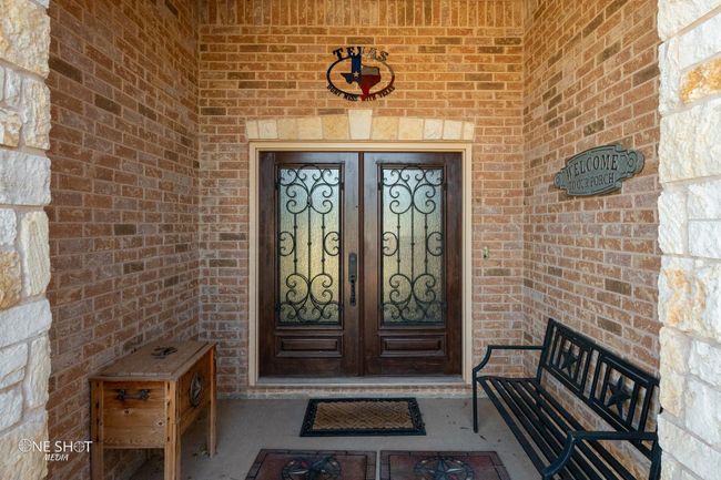 View of exterior entry with french doors and brick siding | Image 5