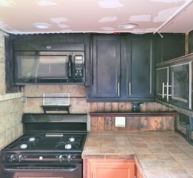 Kitchen featuring black appliances and tile counters | Image 11