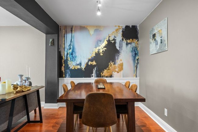 Dining space featuring accent wall, track lighting and wood-style flooring | Image 6