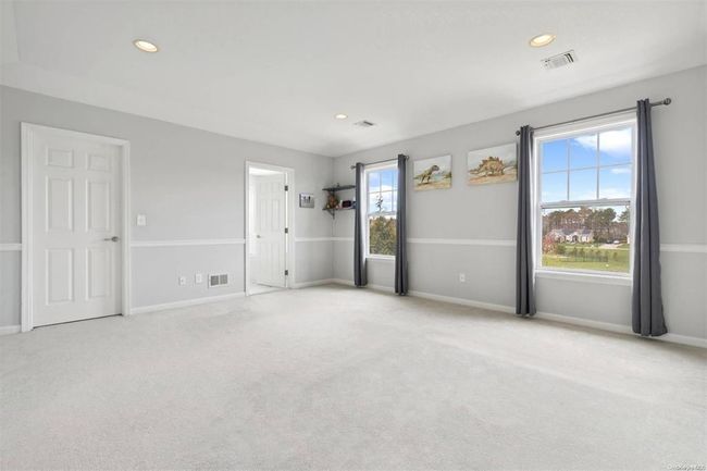 Empty room with carpet flooring, recessed lighting, and baseboards | Image 14