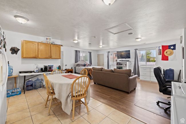 Dining space with attic access, a textured ceiling, and light tile patterned floors | Image 45