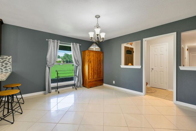 Formal dining room is perfect for gatherings with family and friends. Between the dining room, breakfast nook and bar areas, you will have plenty of room for the whole gang! | Image 7