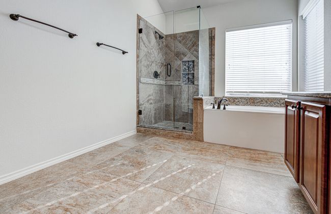 Bathroom with a garden tub, baseboards, and a stall shower | Image 22