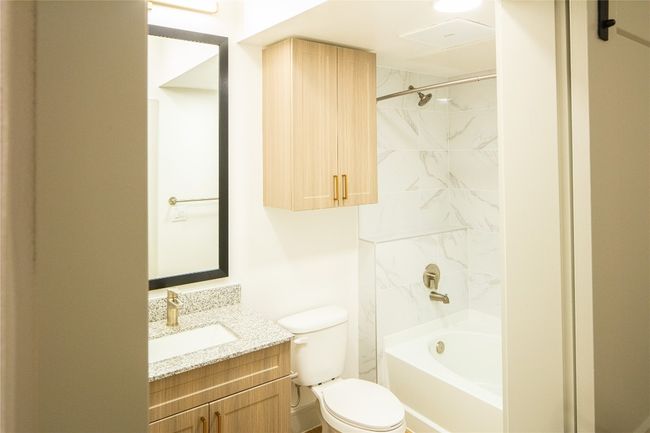 Bathroom with toilet, shower / tub combination, and vanity | Image 12
