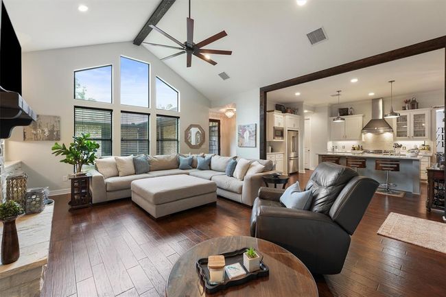 Formal living room with abundance of windows looking into the courtyard | Image 12