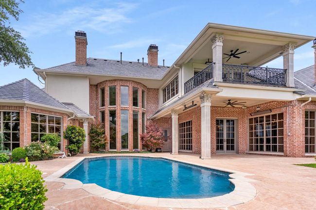 Back of property with a balcony, ceiling fan, and brick siding | Image 38