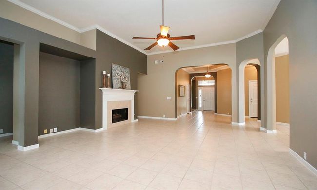 This family room is enhanced by beautiful archways and designer paint which can be seen throughout the home. | Image 9