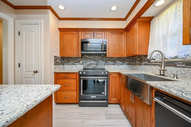 Granite countertops, custom-made cabinets, matching appliances, farmhouse sink and pantry make meal prep a pleasant experience! | Image 10