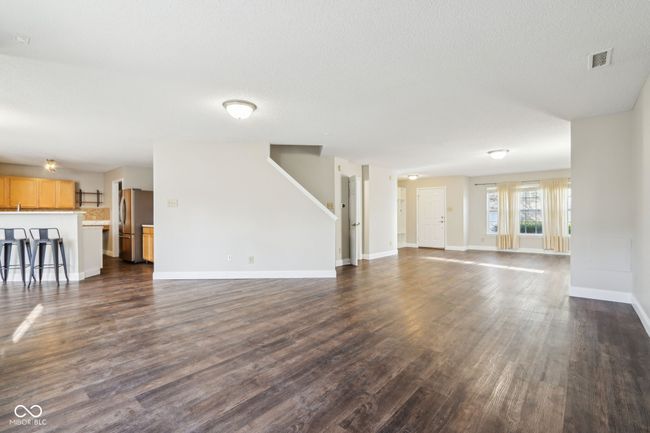 unfurnished living room featuring dark wood-type flooring and baseboards | Image 16