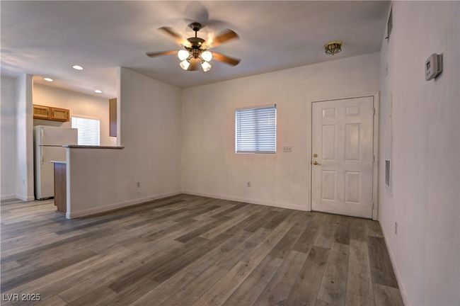 Unfurnished living room with ceiling fan, wood finished floors, baseboards, and recessed lighting | Image 4