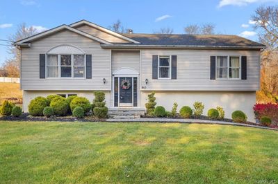 Raised ranch with a front lawn with a nice landscaper and stone walk way. | Image 1