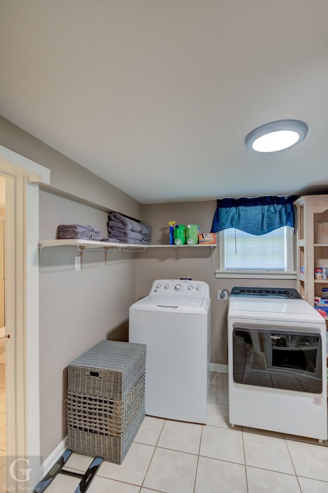 Laundry room featuring washer and dryer, tile patterned flooring, and baseboards | Image 14