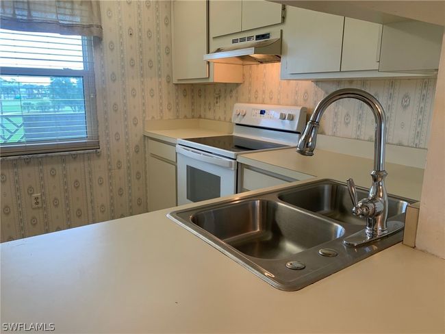 Kitchen with electric range and sink | Image 4