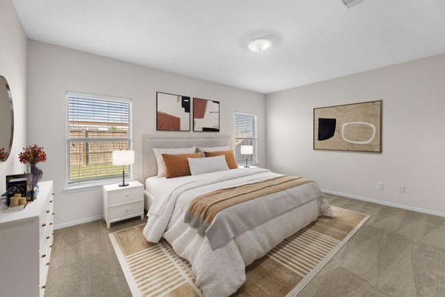The primary bedroom is generously sized, creating a tranquil and spacious retreat that offers ample room for relaxation. Featuring plush carpet, high ceilings, fresh paint, and large windows that lets in natural lighting throughout the day. Virtually staged to show furniture placement. | Image 17