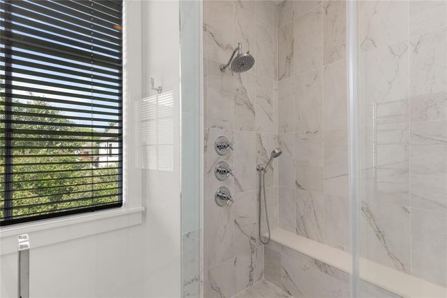 Chrome shower head, rain shower head & hand held shower head; Wall Towel Warmer just outside shower. | Image 36