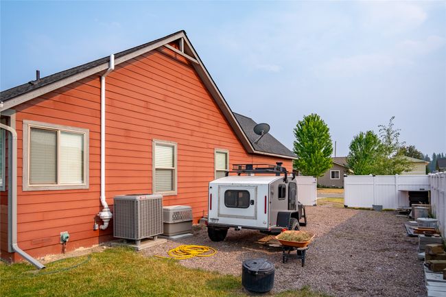 Rear view of house featuring fence and central air condition unit | Image 20