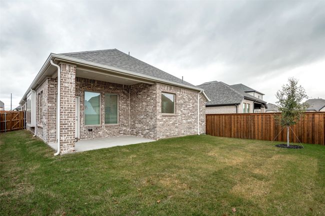 Rear view of property featuring a yard and a patio | Image 25