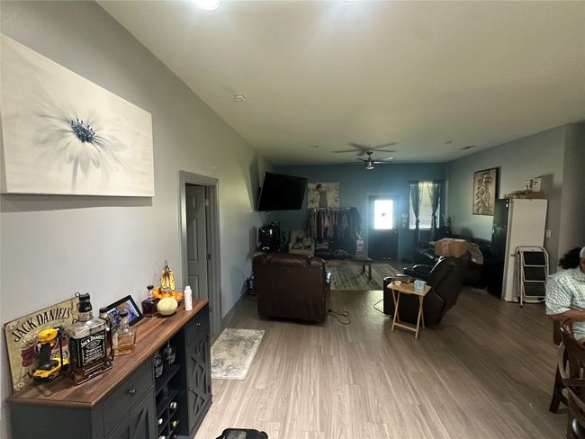 Living area with a ceiling fan and light wood-style flooring | Image 31