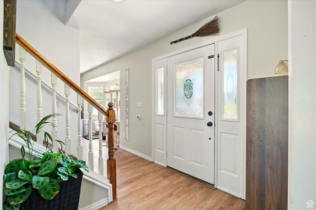 Entryway with light wood-style flooring, stairway, and baseboards | Image 10