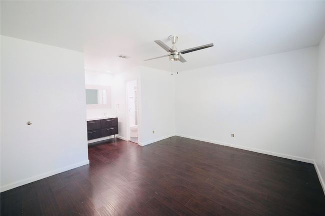 Master Bedroom with dark wood-type flooring and ceiling fan | Image 27