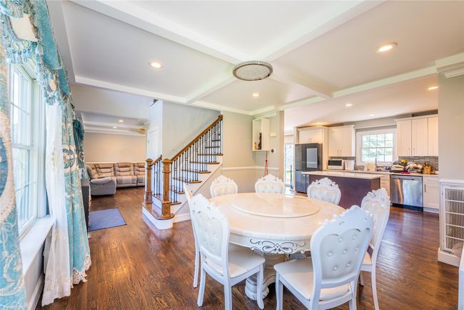 Dining space featuring stairway, dark wood-style flooring, recessed lighting, beam ceiling, and coffered ceiling | Image 14