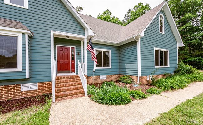 View of front facade with a shingled roof and crawl space | Image 10