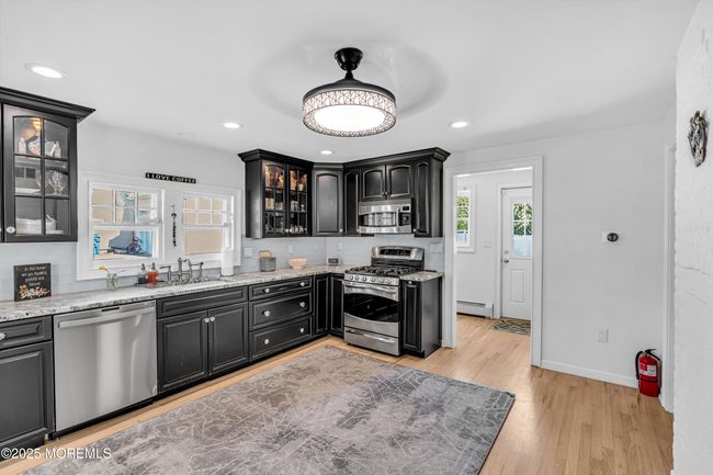 Glass front raised panel cabinets to display fine china & stemware | Image 14