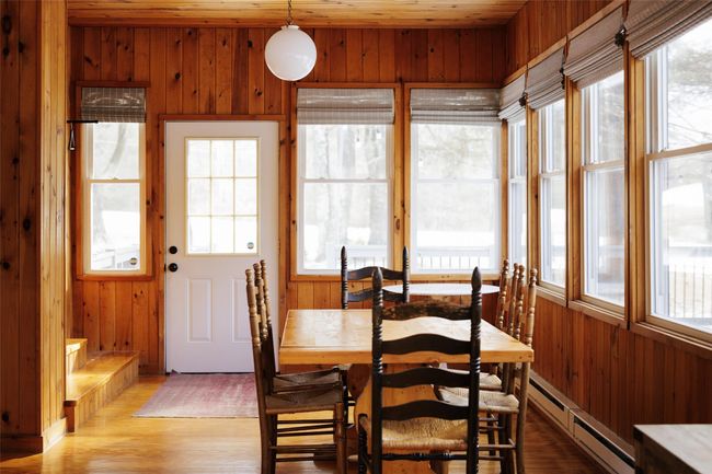 Dining space with a baseboard radiator, light hardwood / wood-style floors, a healthy amount of sunlight, and wood walls | Image 24