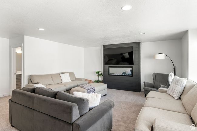 Living room with light carpet, recessed lighting, and a textured ceiling | Image 20