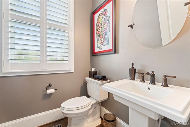 Bathroom with baseboards, a sink, and toilet | Image 20